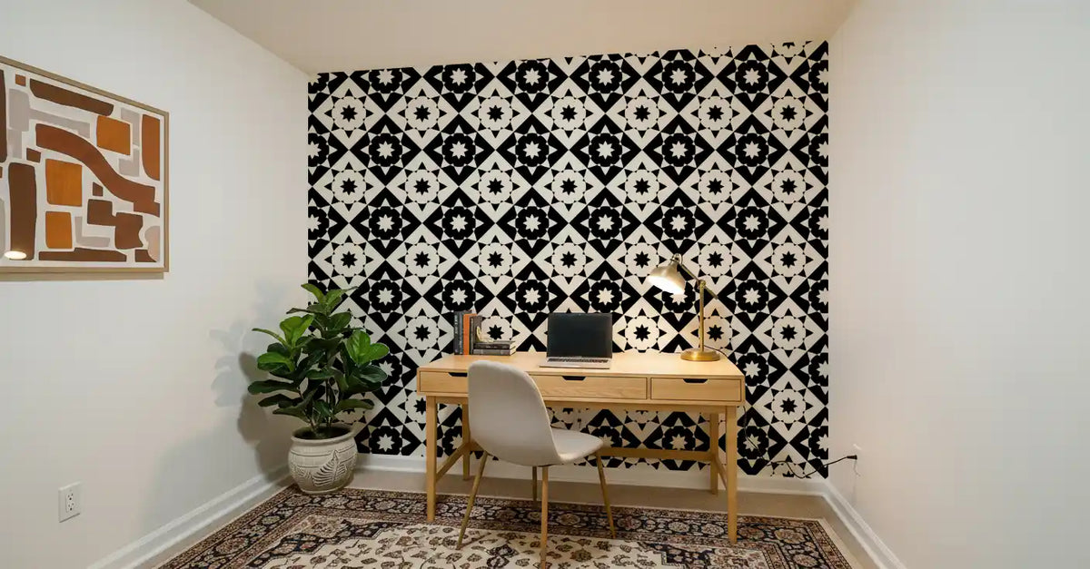 Geometric starburst wallpaper behind a wooden home office desk and chair GD12503