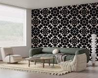Monochrome circle wallpaper in a living room with a green sofa and cream chair GD12506