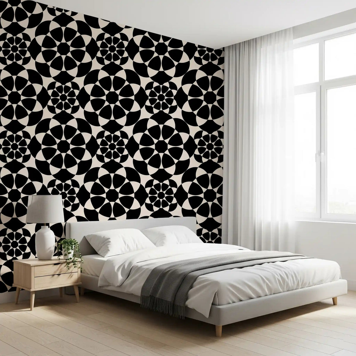 Geometric circle wallpaper behind a white bed with a wooden nightstand and grey throw GD12506