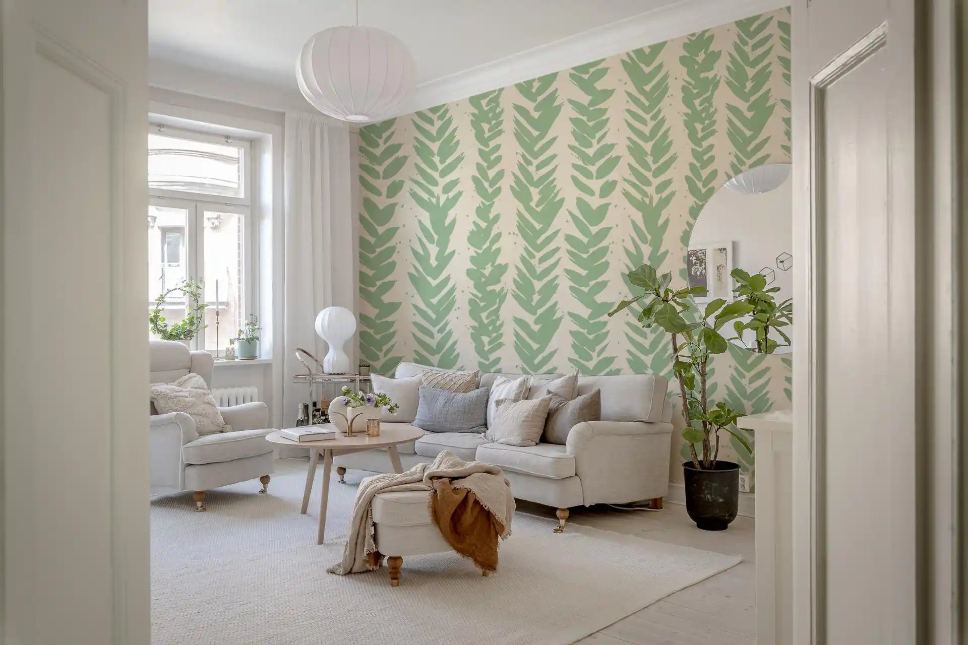 Sage brushstroke herringbone wallpaper behind a white sofa in a bright Scandinavian living room GD12669