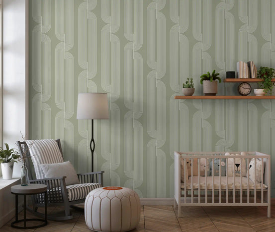 Sage green linear wallpaper in a nursery with a grey armchair and white crib GD12699