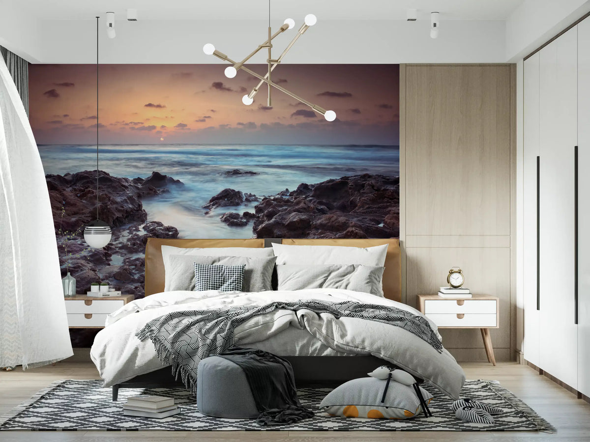 Rugged shoreline at dusk mural behind a grey bed in a modern bedroom GD12779