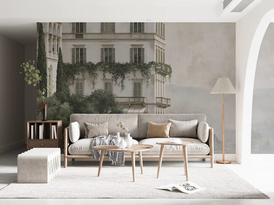 Grey sofa and wood coffee table against a misty lakefront manor mural GD12885