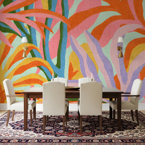 Colorful abstract botanical foliage wall mural behind a wood dining table with cream chairs GD12925