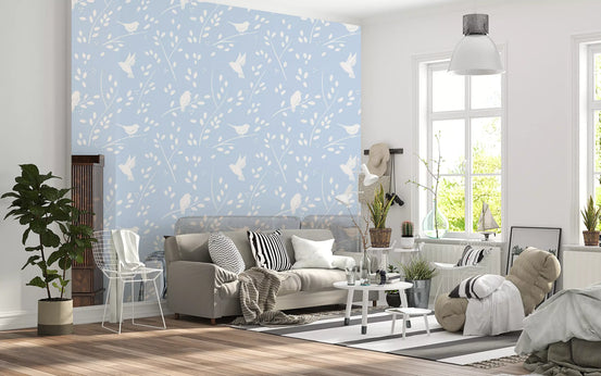 Soft pastel blue woodland birds wallpaper in a bright living room with a grey sofa GD12979