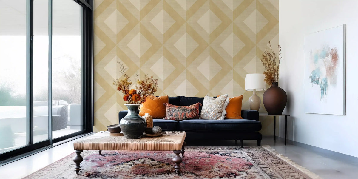 Golden geometric wallpaper behind a navy sofa in a bright living room GD13022