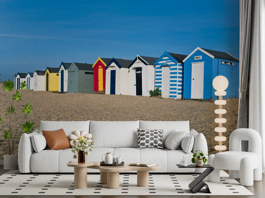 Colorful beach huts mural behind a white sofa in a bright living room GD13028