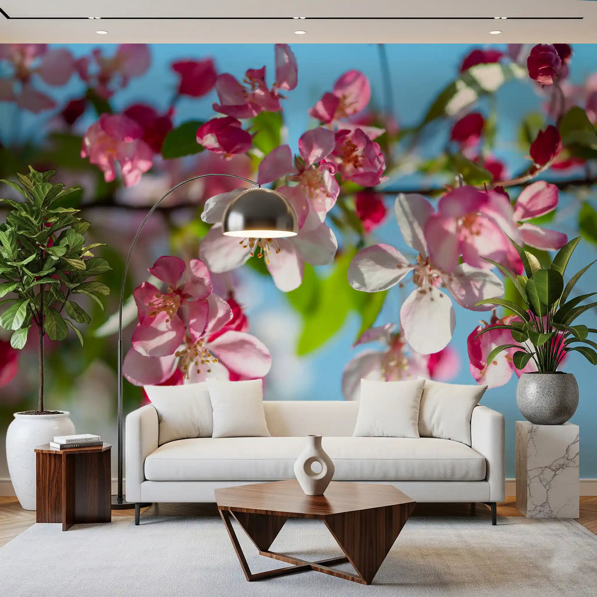 Pink blossom mural in a living room with a white sofa and potted plant GD13035