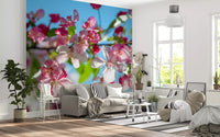 Cherry blossom wallpaper in a living room with a grey sofa and plants GD13035