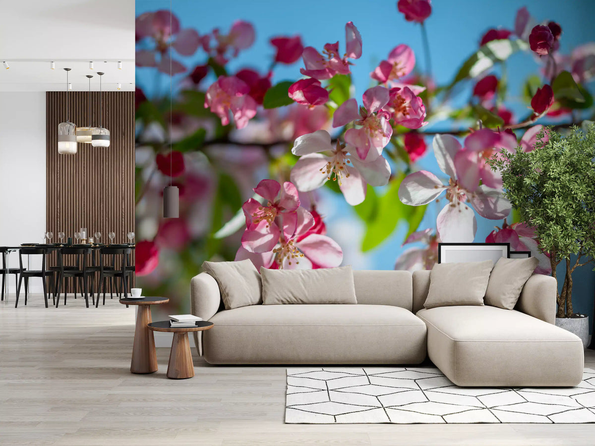 Pink blossom mural in a living room with a beige sofa and dining area GD13035
