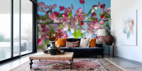 Cherry blossom wallpaper in a lounge with a navy sofa and orange cushions GD13035