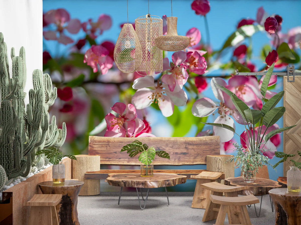 Cherry blossom wallpaper in a boho living room with cacti and a wood table GD13035
