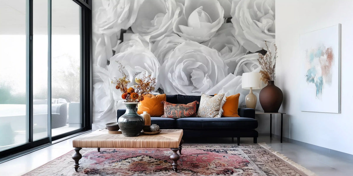 Black and white wallpaper of roses behind a navy sofa and patterned rug GD13038