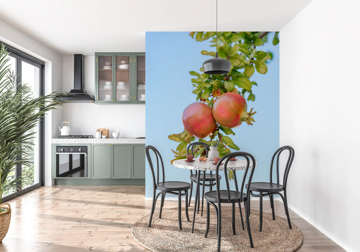 Botanical wallpaper mural of pomegranates behind bistro chairs and round table in sage kitchen GD13163