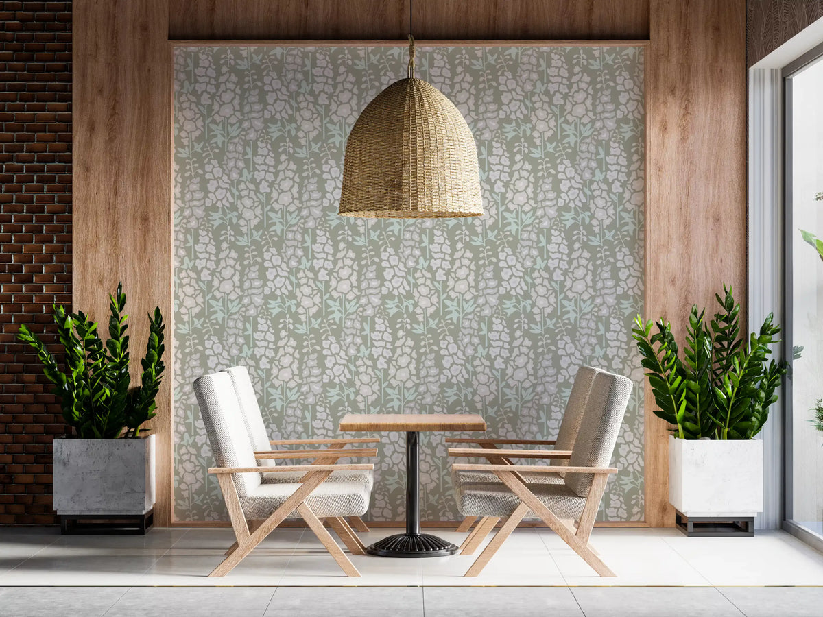 English garden wallpaper behind two cream armchairs and a small wood bistro table GD13224