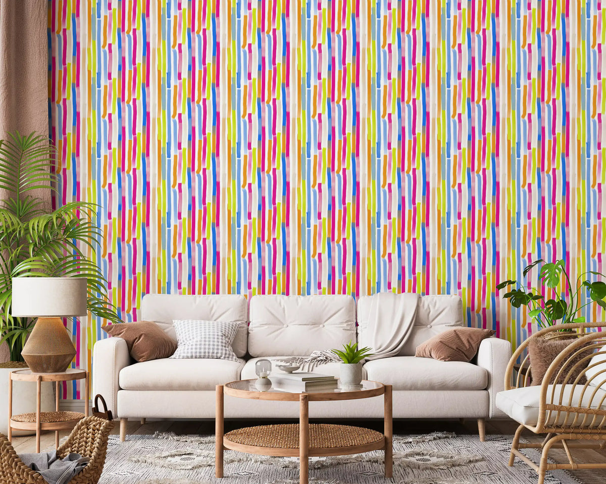 Cream sofa, rattan chair and palm plant before multicolor brush stroke wallpaper GD13316