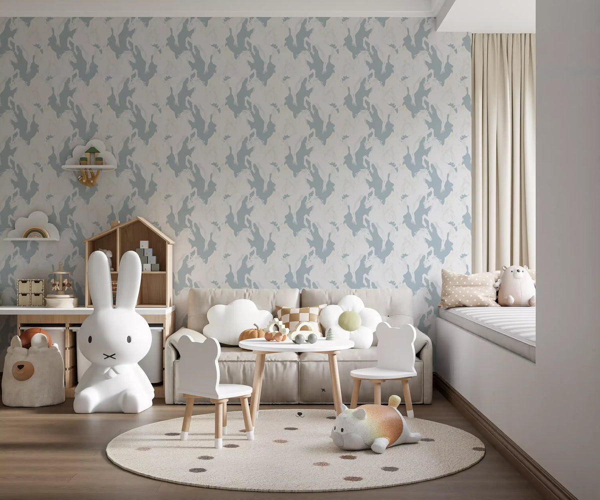 Nursery wallpaper with blue pegasus behind a bunny lamp, cloud sofa and small play table GD13371