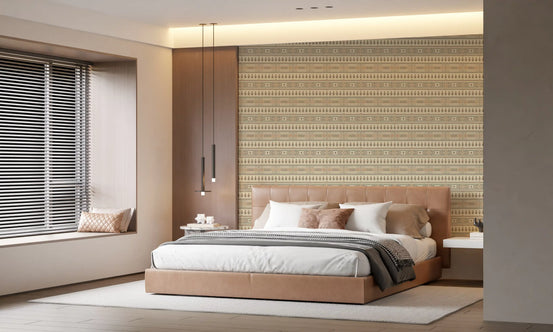 Beige wallpaper behind a tan upholstered bed with gray throw and window blinds GD13585