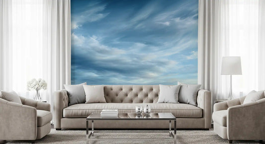 Cloud wallpaper behind a tufted taupe sofa, glass coffee table and matching armchairs GD13634
