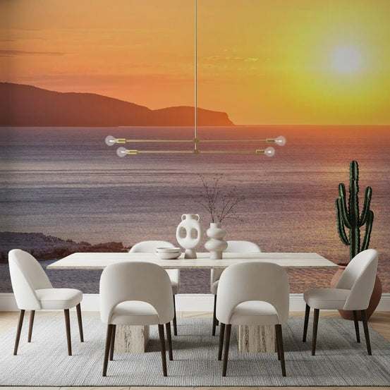 Ocean wallpaper mural in a dining room with a white table, cream chairs and a cactus GD13685