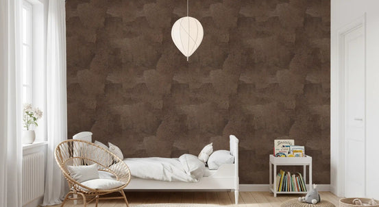 Brown wallpaper in a kids bedroom with white metal bed, rattan egg chair and bookshelf GD13742