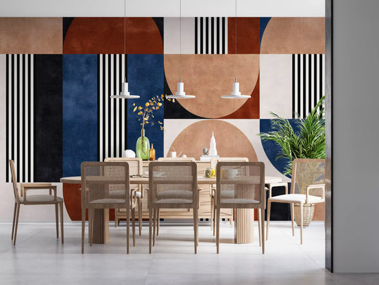 Geometric wallpaper mural behind a wood dining table with cane chairs and white pendants GD13811