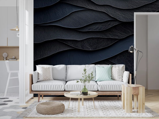 Surface wallpaper of navy leather waves behind a white sofa, round table and pouf GD13817