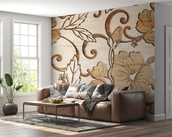 Floral wallpaper with carved wood hibiscus behind a brown leather sofa in a bright living room GD13929