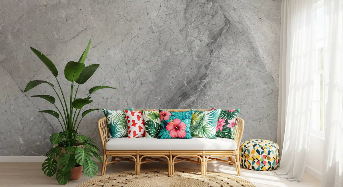 Rattan bench with tropical print cushions and bird of paradise plant on gray marble wallpaper GD14034