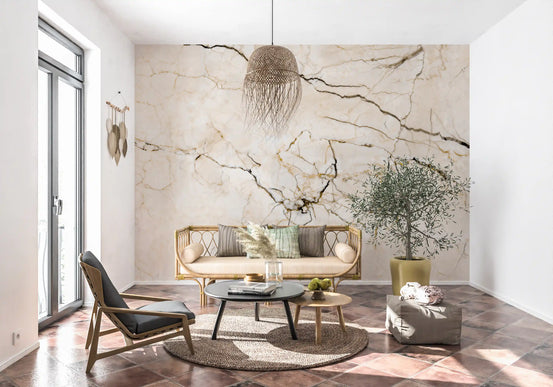 Marble wallpaper mural behind rattan sofa, olive tree and black lounge chair on terracotta floor GD14038