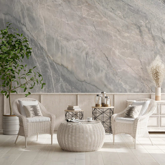 White wicker armchairs and a woven pouf table in a sunroom with gray marble wallpaper GD14062