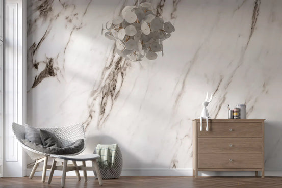 White marble wallpaper mural with gray lounge chair and wood dresser GD14087