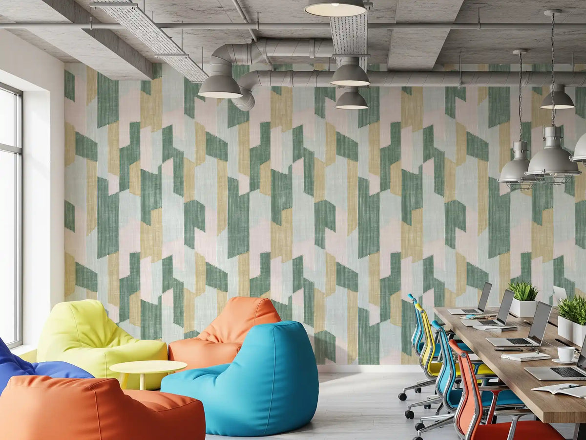 Office with colorful bean bags and long desk against pastel painted block wall GD14169