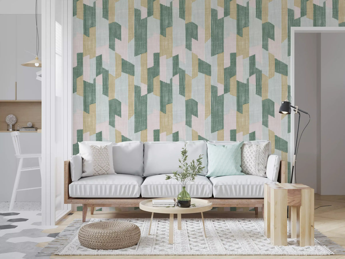 Light wood sofa with mint cushion and knit pouf on sage and pink painted wall GD14169