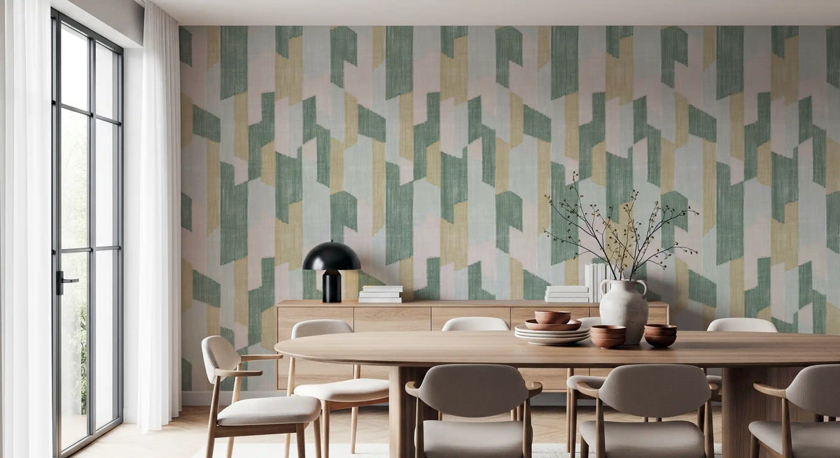 Round wood dining table and beige chairs against sage and blush geometric wallpaper GD14169