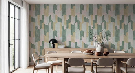 Round wood dining table and beige chairs against sage and blush geometric wallpaper GD14169