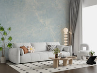 White sofa with flower cushion and checked rug against ethereal marble wallpaper GD14187
