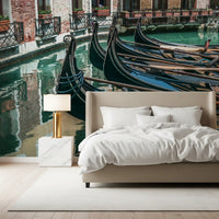 Gondola mural behind beige upholstered bed with gold lamp and marble nightstand GD14197