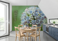 Kitchen dining nook with a round wood table and navy cabinets on floral wallpaper GD14202