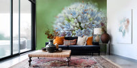 Navy velvet sofa with orange cushions and a Persian rug on allium floral wallpaper GD14202
