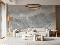 Cream sofa and curved coffee tables below a ring chandelier on marble wallpaper GD14203