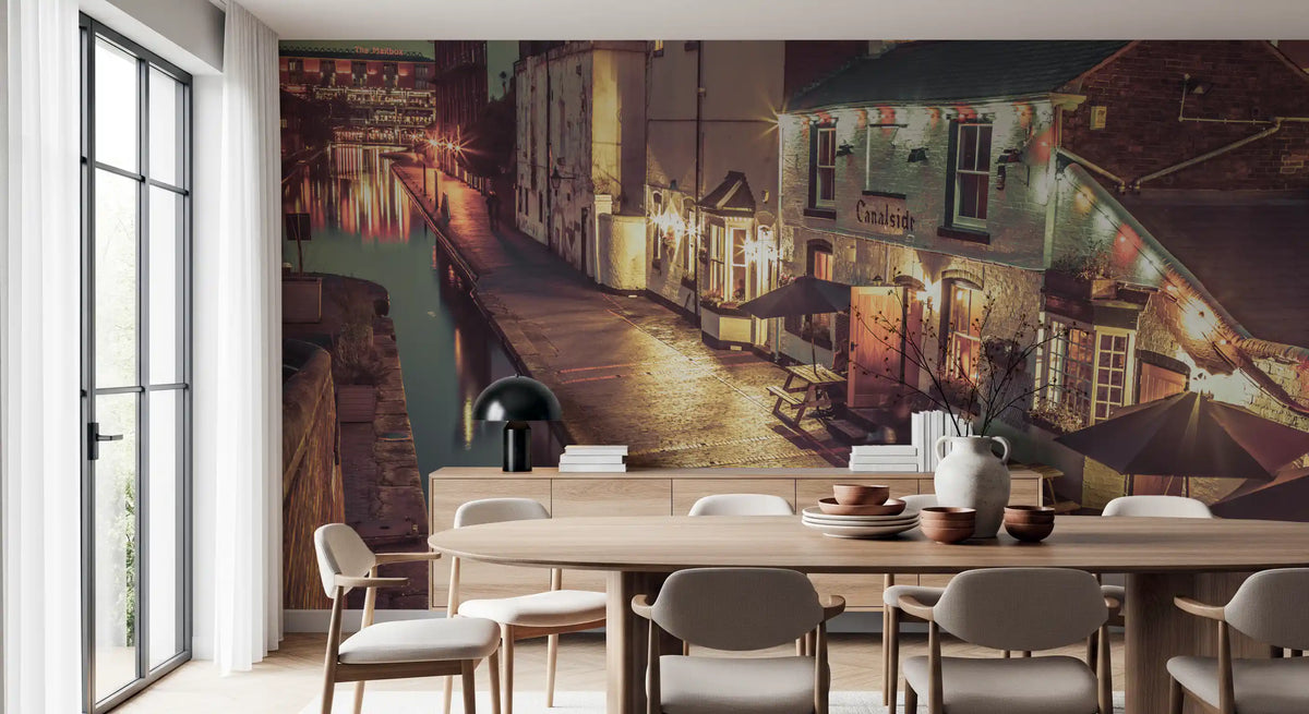 Round wood dining table and gray chairs before a vintage canal path mural GD14208