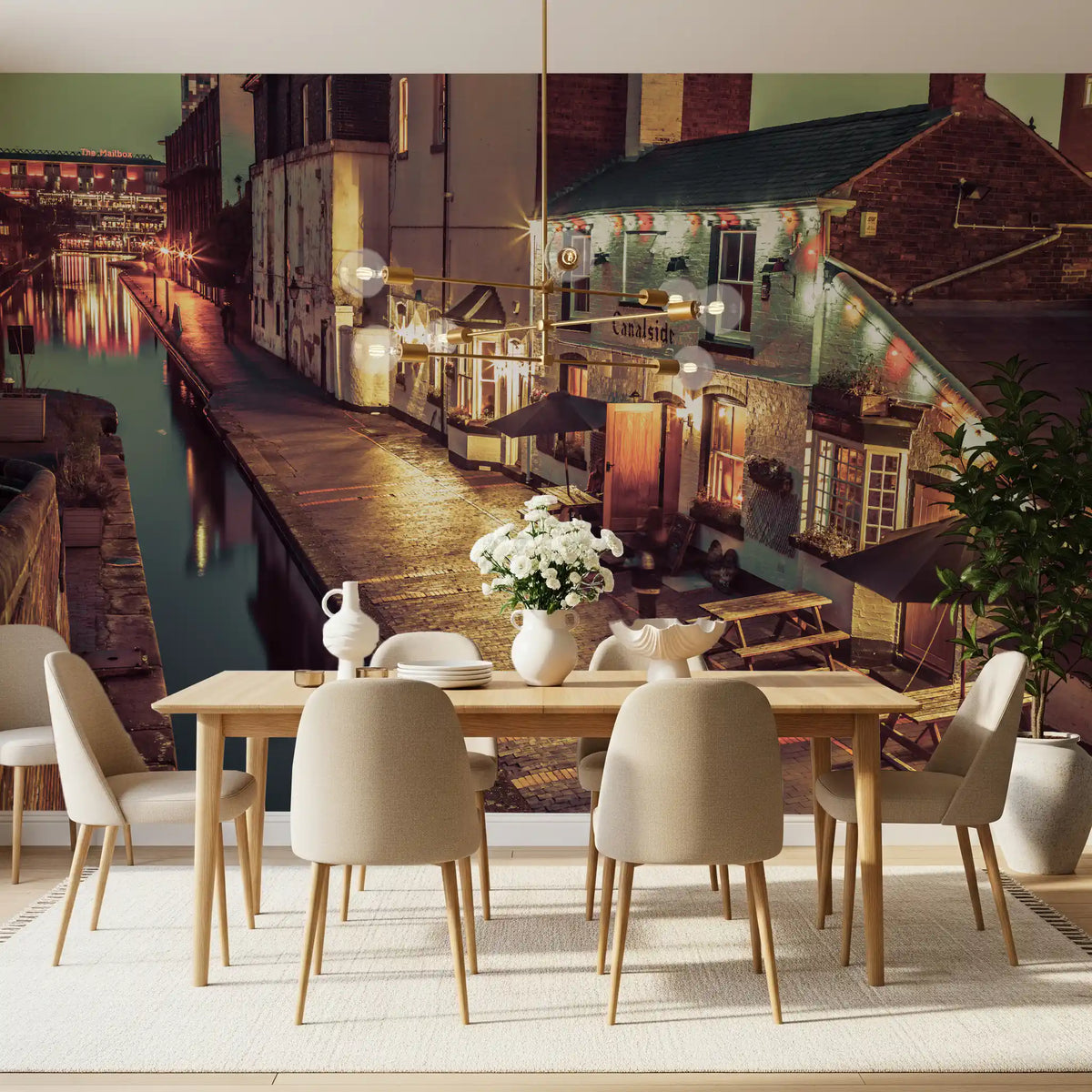 Long dining table with cream chairs and white flowers by a canal pub scene GD14208