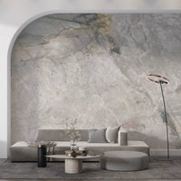 Marble wallpaper under a white arch behind a low gray sofa and houndstooth pouf GD14211