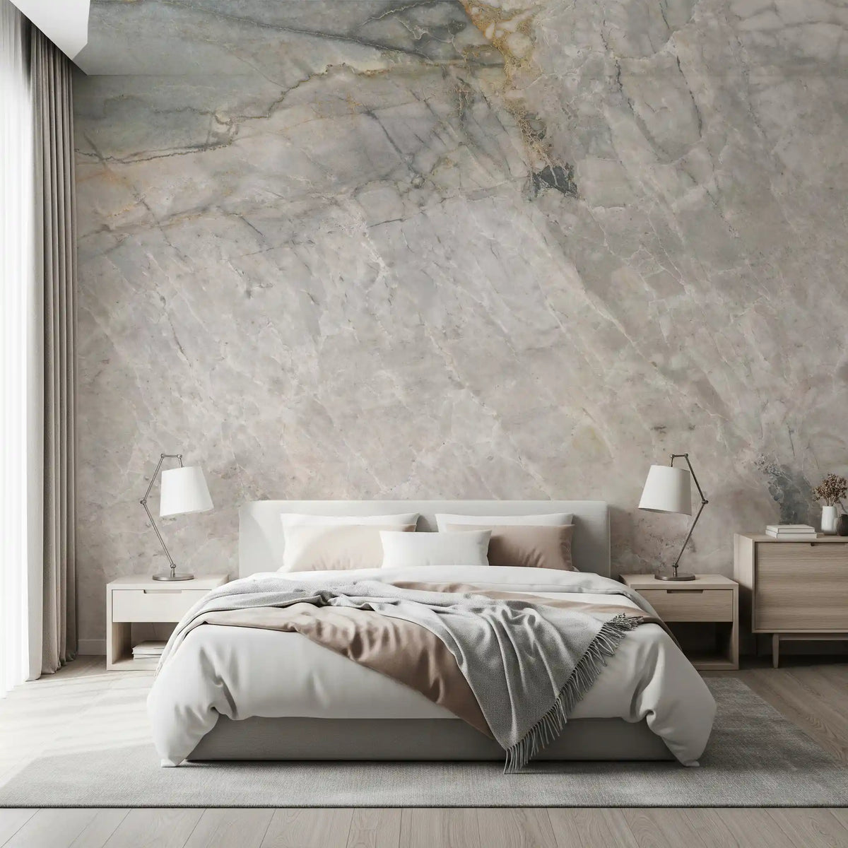 Gray marble mural behind a white upholstered bed with beige throw and bedside lamps GD14211