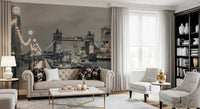 London wallpaper behind a tufted beige sofa with floral cushions and gray armchairs GD14214