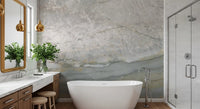 Marble wallpaper behind a freestanding tub and wooden vanity with gold mirror GD14215