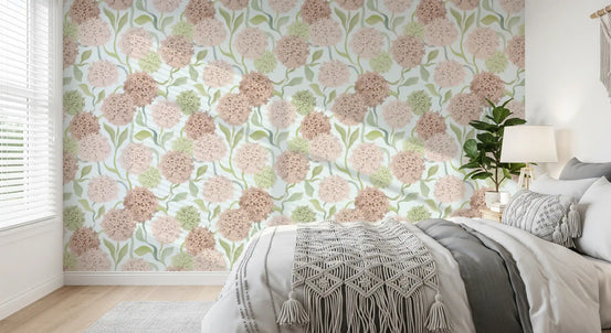 Blush watercolor petal clusters wallpaper in a bedroom with grey linen and a bedside lamp GD12712