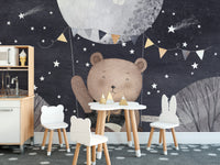 Bear and balloon mural set against a serene starry night backdrop.
