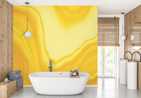 Bright yellow metallic wallpaper mural with swirls
